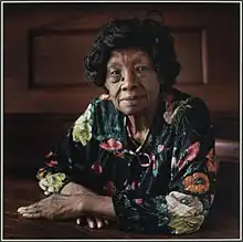 Portrait of Minnie L. Fisher sitting at a table