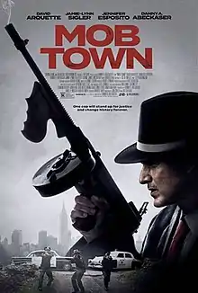 Poster showing a man in a fedora looking over his shoulder and  holding a tommy-gun as three police officers approach in the background