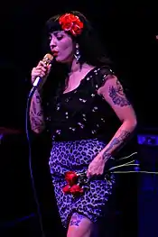 A color photograph of Mon Laferte performing.