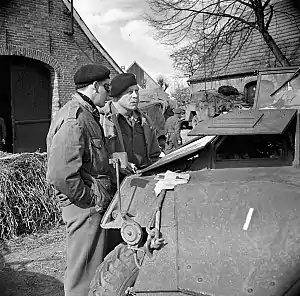 Major-General Christopher Vokes in discussion with Brigadier Robert Moncel standing in a street in Sögel on 10 April 1945