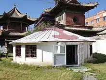 Low, round white building with a conical roof