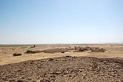 Looking south, the Hejaz railway station building in the distance behind the village