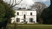 A south-side view of Mulberry House, the former rectory. A horse which belongs to the grounds is shown directly to the left