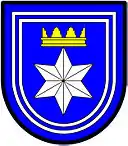 a double tressure—Azure; a facetted six pointed star [mullet] argent ensigned with a gable crown or, the whole within a double tressure argent—Langenhoven, RSA