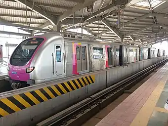 Grey-and-pink electric train at a station