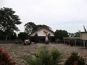 Museum, religious goods store and dairy store, as well parking lot.