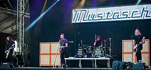 Mustasch performing in 2018