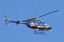 A helicopter wrapped in blue, red, and black, with the NBC Action News logo and the word Sky Tracker