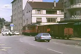 At Nyon in 1979 the narrow-gauge train hauls its load of vans to the CFF goods station.