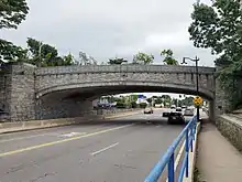An arched concrete bridge over a city street