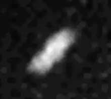 A smeared white object elongated from the bottom-left to top-right can be seen in the center.