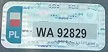 A holographic, rectangular sticker resembling a standard license plate. It reads WA92829
