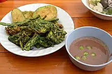 Nam phrik kapi served with vegetable fritters; a common dish in Thai cuisine