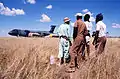 Namibian workers watch operations following the landing of a Military Airlift Command C-5B Galaxy aircraft at Grootfontein Logistics Base.