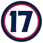 The number "17" in navy blue set against a white circle with a red and navy border