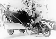 Nassau County Deputy Sheriff tickets Lawrence Sperry after landing plane in street, Circa 1922.