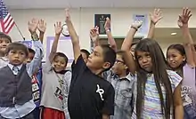 10 children raising their hands