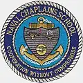 Patch showing US Naval Chaplains School Seal, with "universal" symbols of wisdom and cooperation