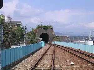 A view of the station tracks looking in the direction of Tokushima. Note the Chōnai Tunnel. The hill it used to punch through has now been removed for land development