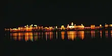 Niramhal at night, the lights of the palace are reflected in the water.