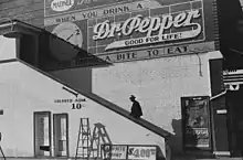 Negro going in colored entrance of movie house on Saturday afternoon, Belzoni, Mississippi Delta, Mississippi