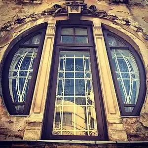 Mix of Art Nouveau and Egyptian Revival – Round corner window of the Romulus Porescu House (Strada Doctor Paleologu no. 12), Bucharest, Romania, decorated with lotus flowers, a motif used frequently in Ancient Egyptian art, designed by Dimitrie Maimarolu (1905)