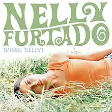 On a white background, Furtado lies on the grass on her side, looking at the camera. "Nelly Furtado" is written in 60s-inspired forest green capital letters, and "Whoa, Nelly!" in smaller, light-blue capital letters.