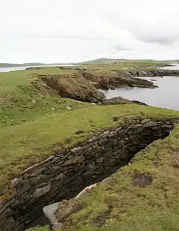 Northern part of the Ness looking inland towards Scatness.  The structure in the foreground is part of the Ness of Burgi fort