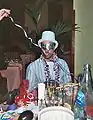 Young man wears a party top hat at a New Year's Party.