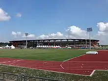 The athletic stadium with the training track oval in the foreground.