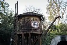 A wooden water tower with the DRR's three-letter logo painted on the side