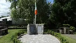 Commemorative plaque and flagpole in Newcastle