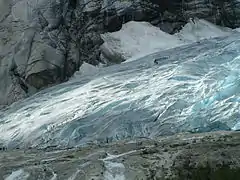 Several groups of people are glacier hiking on the glacier Nigardsbreen