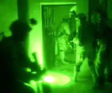 Paratroopers in Fallujah, Iraq, conduct a night raid using Night Vision Goggles