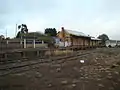 Nimmitabel railway station, closed in 1986. Looking south towards Bombala from the goods shed. The buildings are not maintained and are crumbling