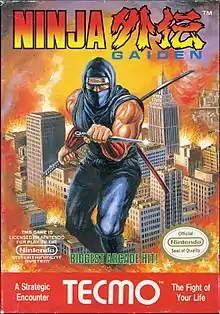 The logo of Ninja Gaiden is on the top of the screen. In the middle of the image is a depiction of a ninja in blue with a knife in his left hand and a bo and katana stored on his back. The ninja is portrayed in a background of a burning city. Below the ninja is green text saying in caps "BIGGEST ARCADE HIT!", and to the left and right of that text are Nintendo's license notice and Seal of Quality respectively. In the bottom of the image, in red with white lettering, is the TE©MO logo, with text to the left of the logo saying "A Strategic Encounter" and with text to the right of the logo saying "The Fight of Your Life".