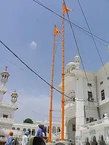Nishan Sahib flags on tall poles over Harmandir Sahib in India