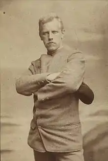 Portrait of a stern and determined looking man with arms crossed.