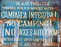 "No Camping" sign displayed on the beach.