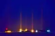 Nocturnal light pillars caused by light reflected through ice fog in Cambridge Bay, Nunavut, Canada