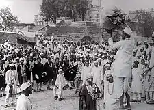 Hindus and Muslims, with flags of Indian National Congress and the Muslim League, collecting clothes to be burnt as a part of the non-cooperation movement