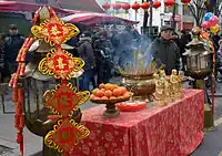 A street altar with Fu, Lu and Shou statues during Chinese New Year 2015 in Paris, France