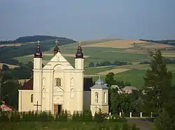 Main street in Nowotaniec, the centre of village. The latin church parish and Bukowica hill.