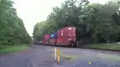 Norfolk Southern westbound train on the Lehigh Line passing through a crossing near Flemington, New Jersey, Picture 3- in back of train part one