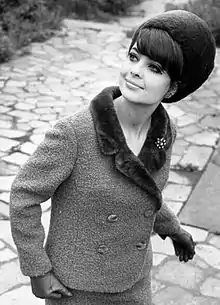 Fashion model from Leipzig, GDR wearing a wool suit trimmed with fur and a matching fur hat, 1966.