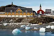 View of Nuuk with the statue of Hans Egede visible in the background atop a hill