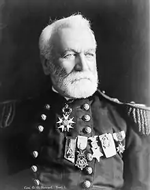 Man with beard looking right in military dress uniform with several medals