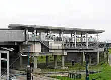 An elevated railway platform with a curved roof