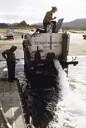 Photo of men stocking trout in a lake