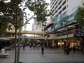 People in a pedestrian mall between buildings
